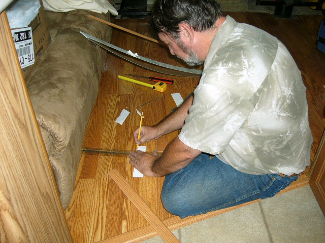 Installing the floor trim.